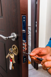 man with screwdriver fixing lock need locksmithing services in west park fl